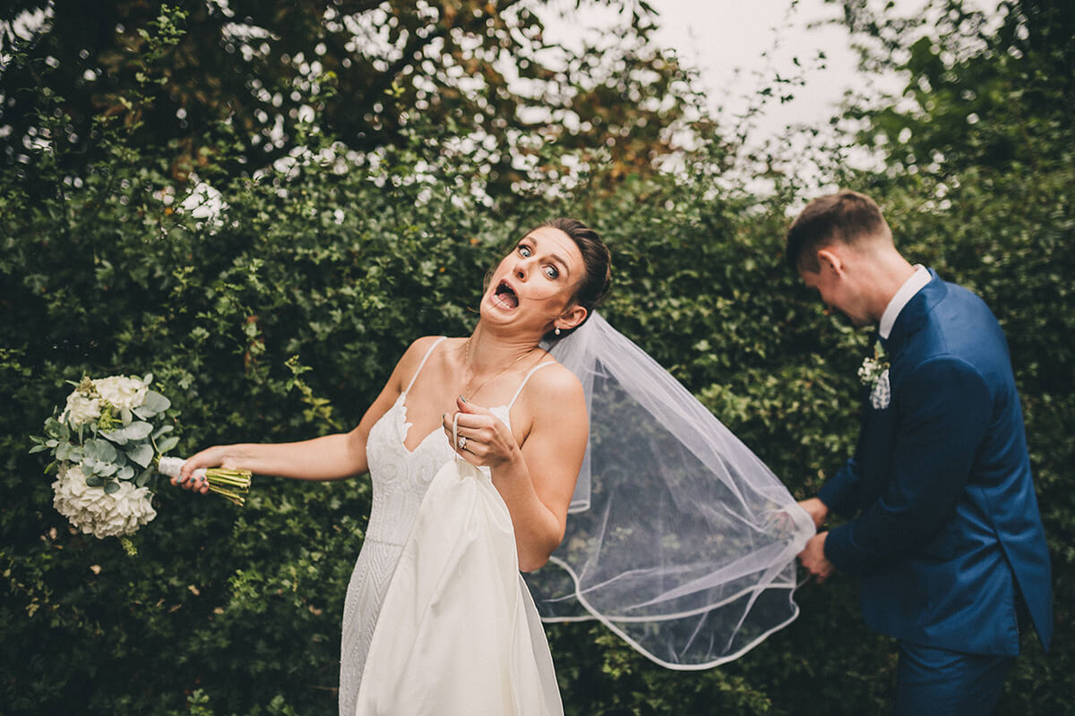 bride gets her veil caught in a bush