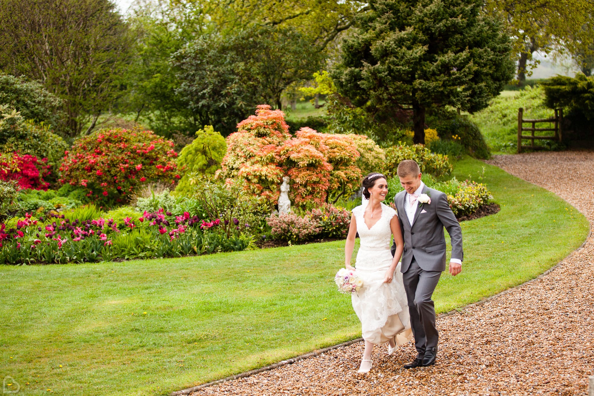 happy newlyweds stroll around moorland garden hotel, a rustic wedding venue in the uk