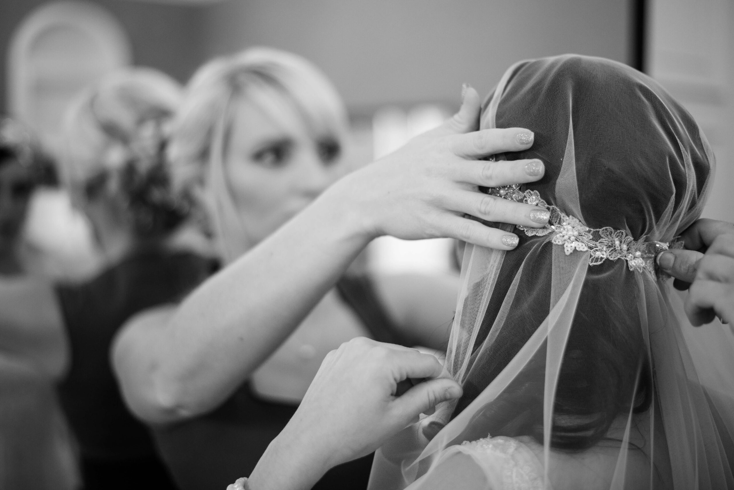 Bridebook.co.uk bride putting on cap veil