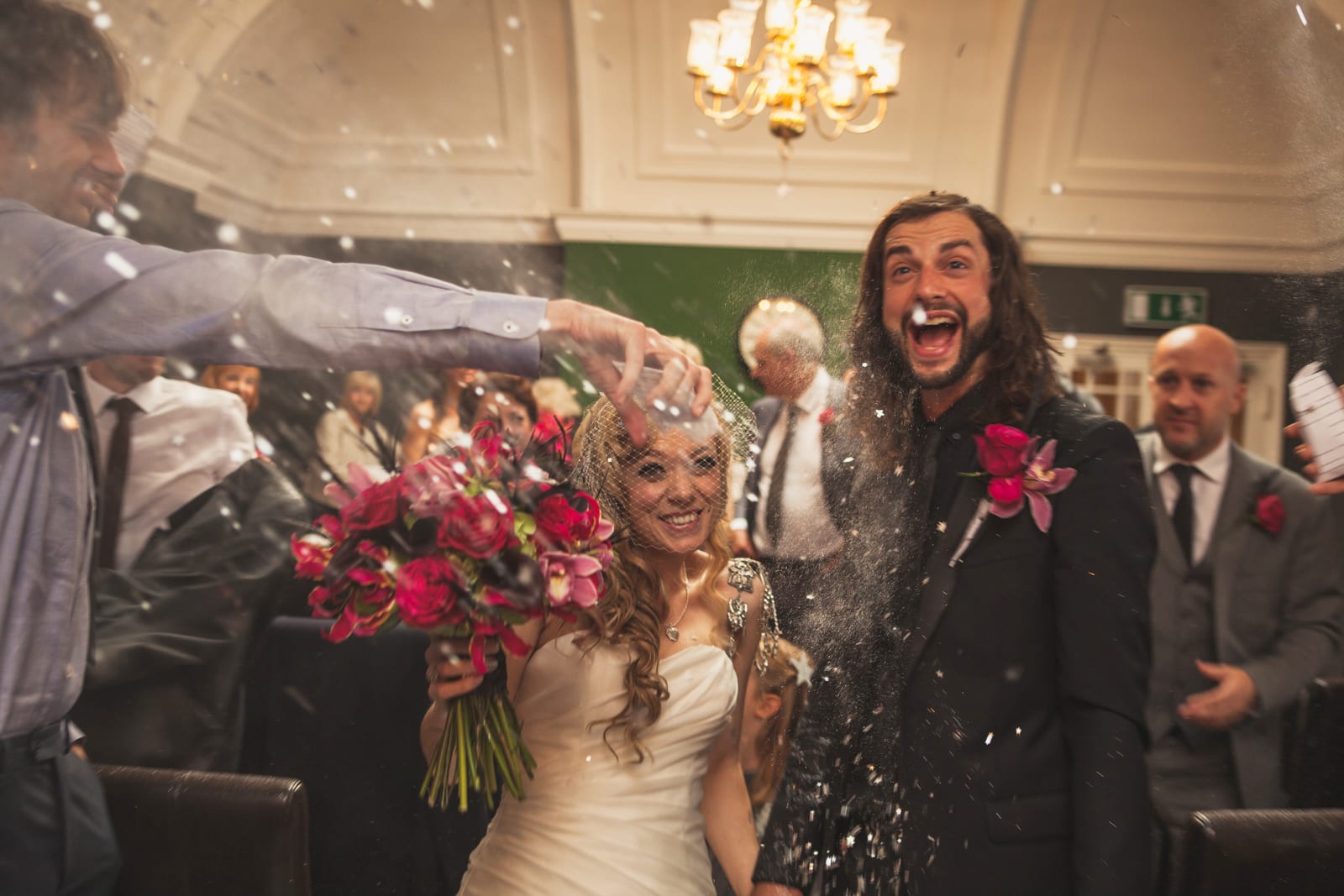 bridebook.co.uk happy couple being showered in confetti
