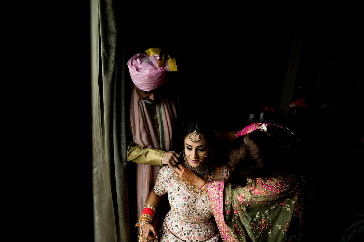 indial wedding parents helping the bride get ready