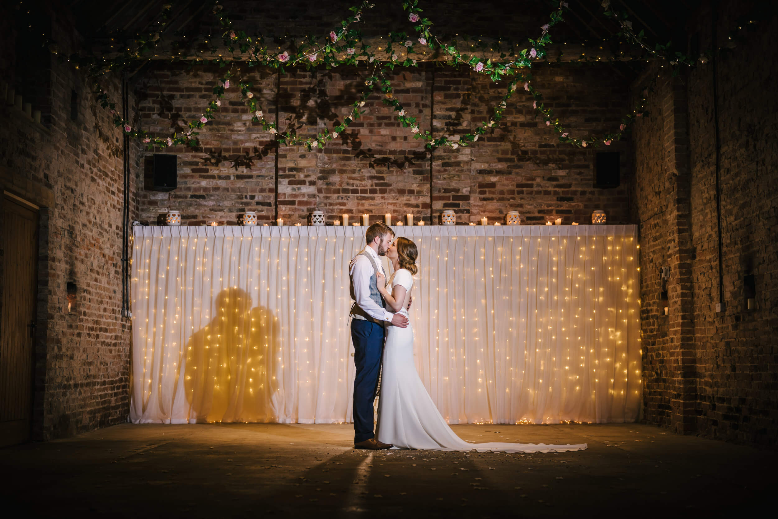 newlyweds kiss at barmyfield barns a barn wedding venue in york