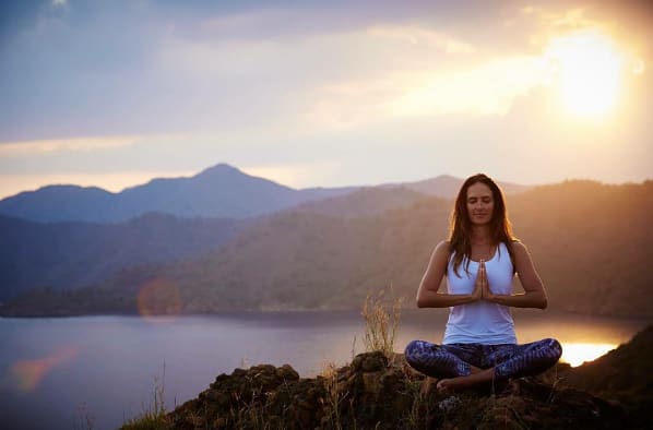 bridebook.co.uk young woman doing yoga in the mountains