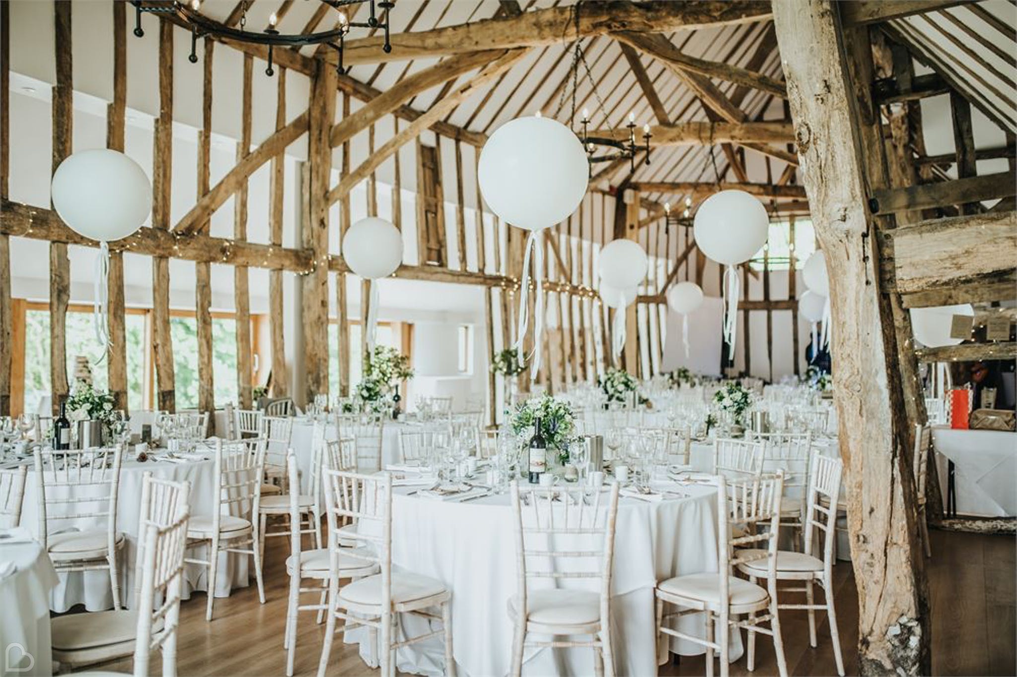 colville hall decorated with white circular lamps for a wedding, a barn venue in the uk