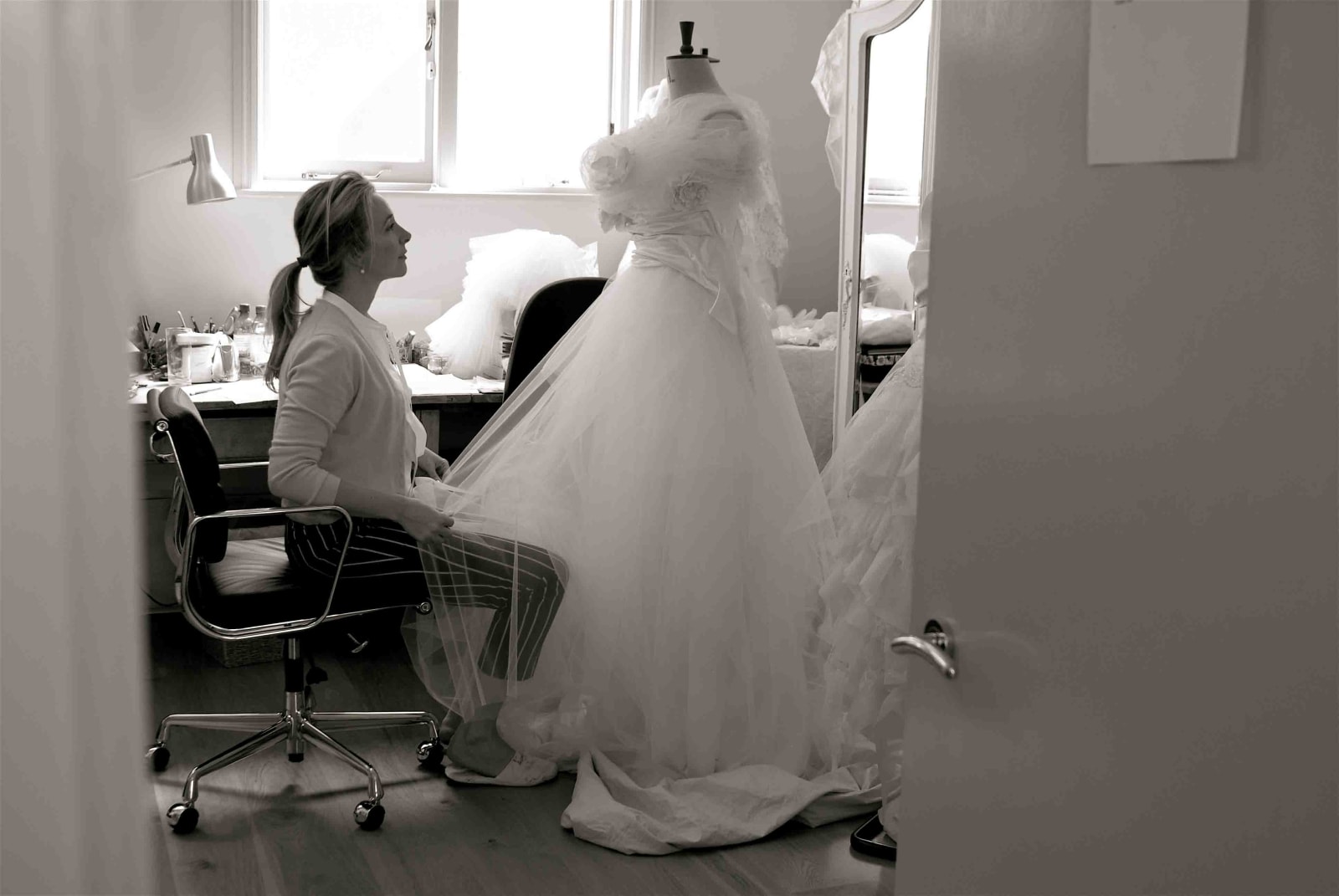 bridebook.co.uk phillipa lepley at work on a dress in her studio