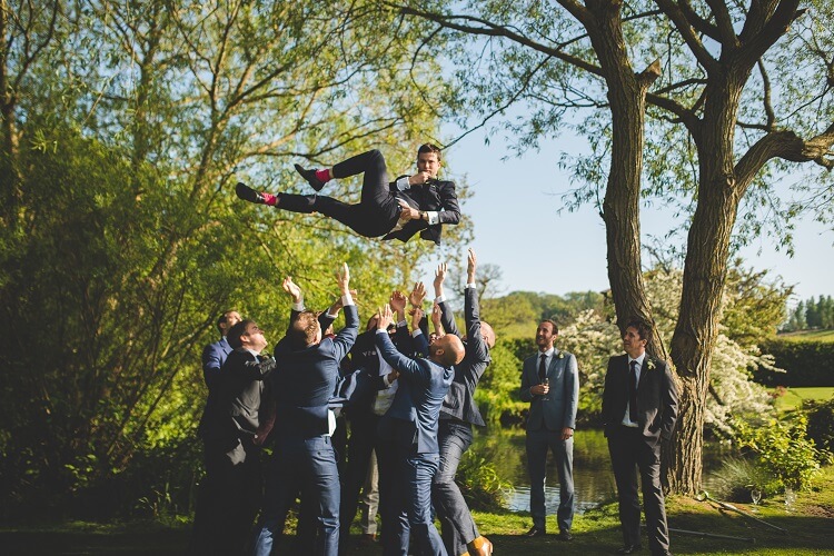 bridebook.co.uk groomsmen throw groom in the air