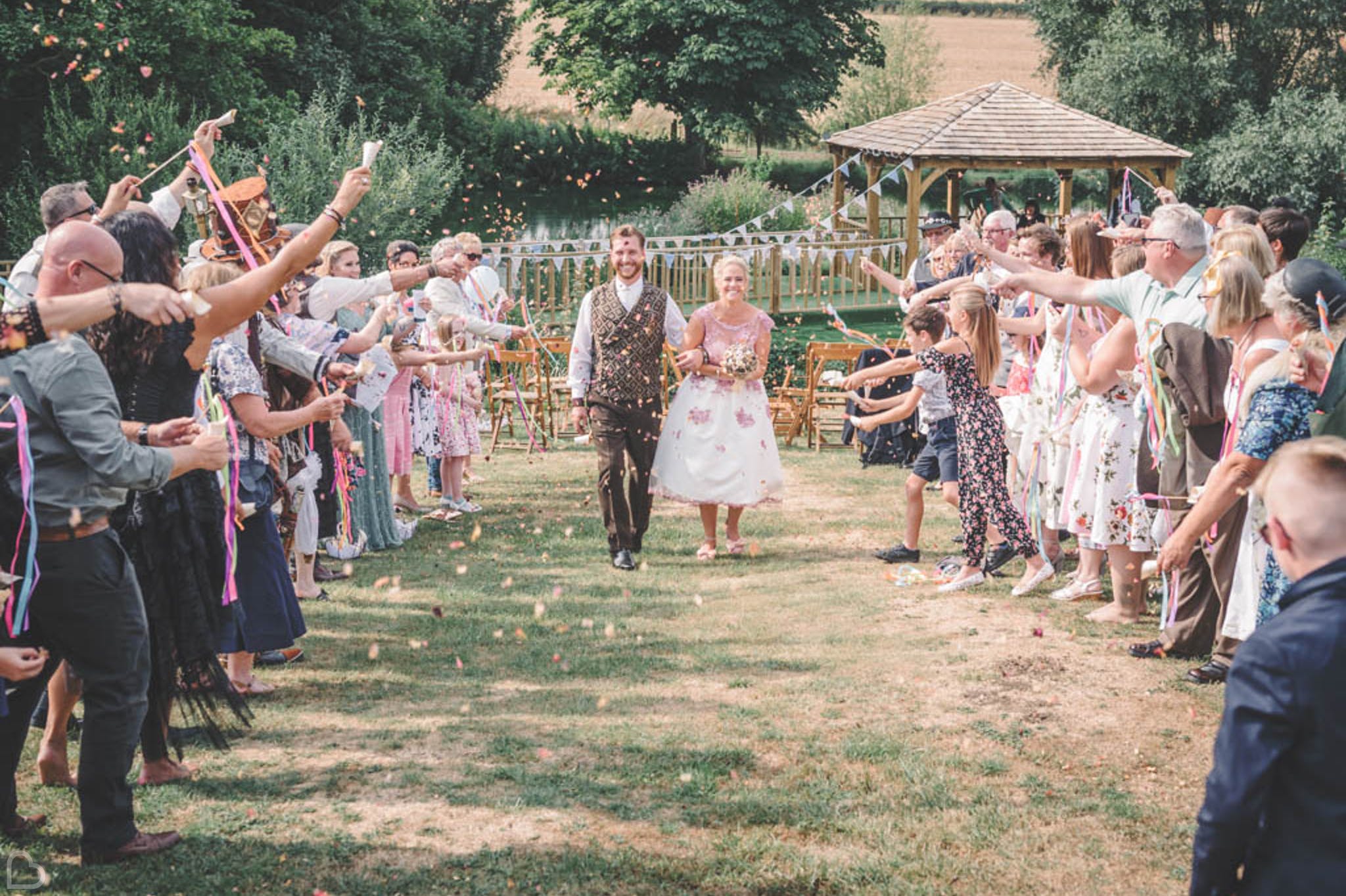 a happy couple celebrates at furtho manor farm wedding venue