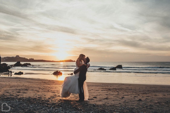 married couple kiss on Lusty Glaze Beach, a wedding venue in Cornwall