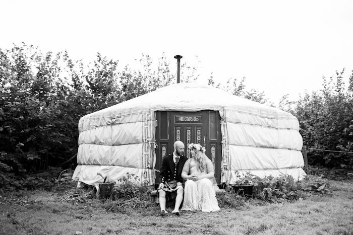 Bride and groom sit outside Plan-It Earth, a small wedding venue in the uk