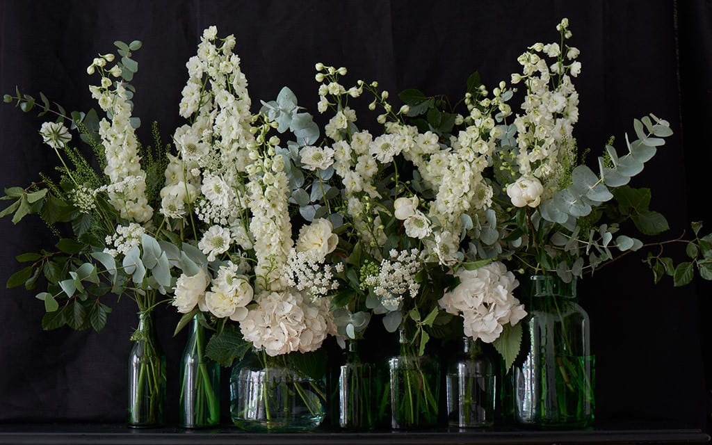 bridebook.co.uk pale flowers in glass vases