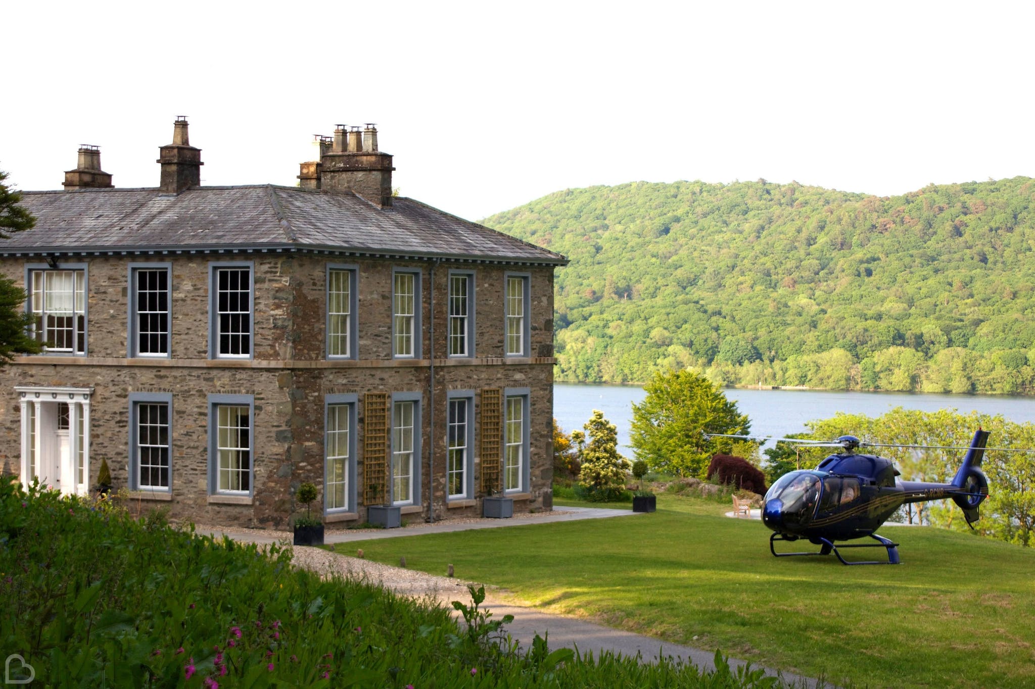 a helicopter is parked outside silverholme manor, a country house wedding venue in the uk
