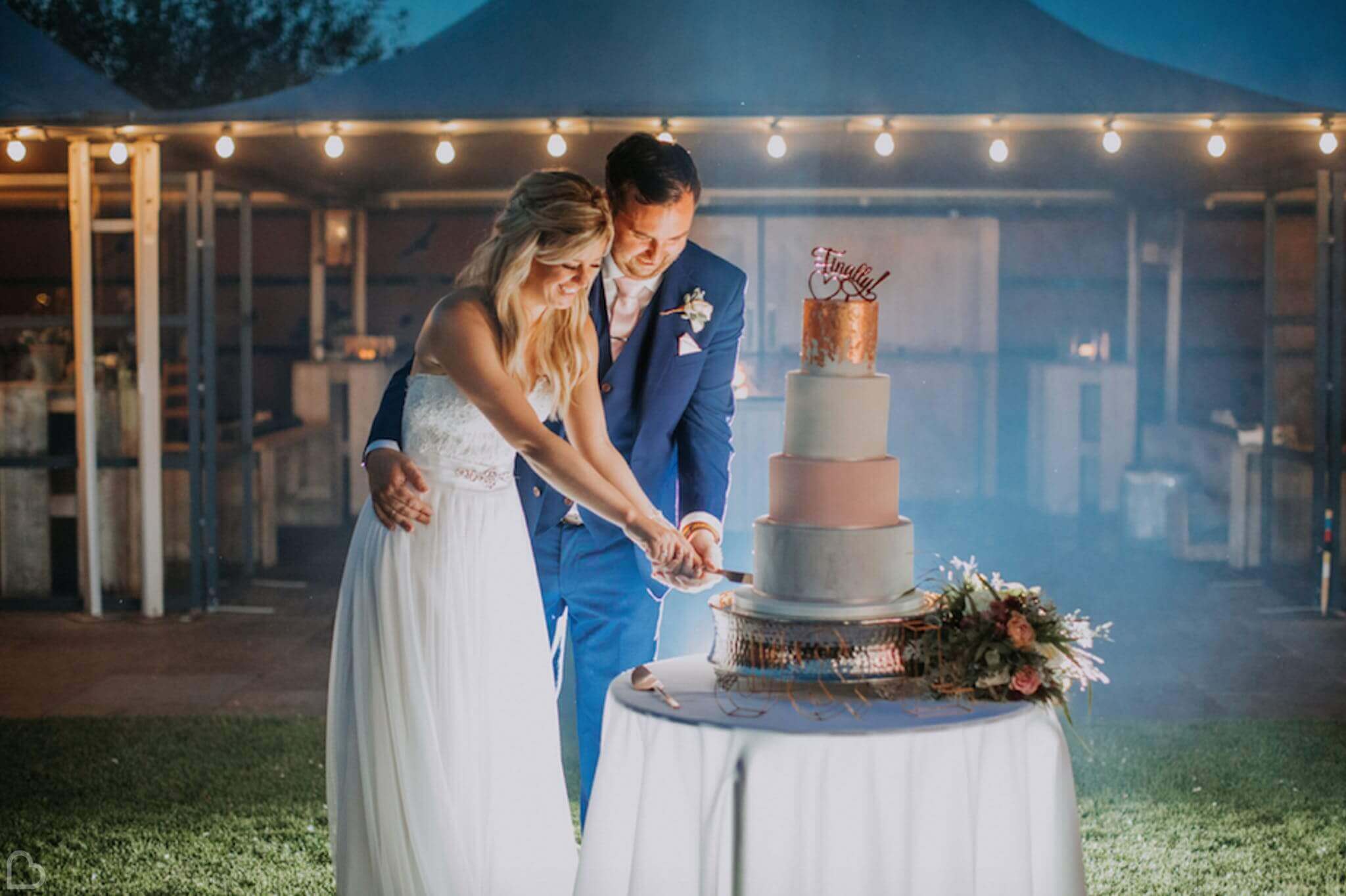 newlyweds cutting their wedding cake at southend barns wedding venue