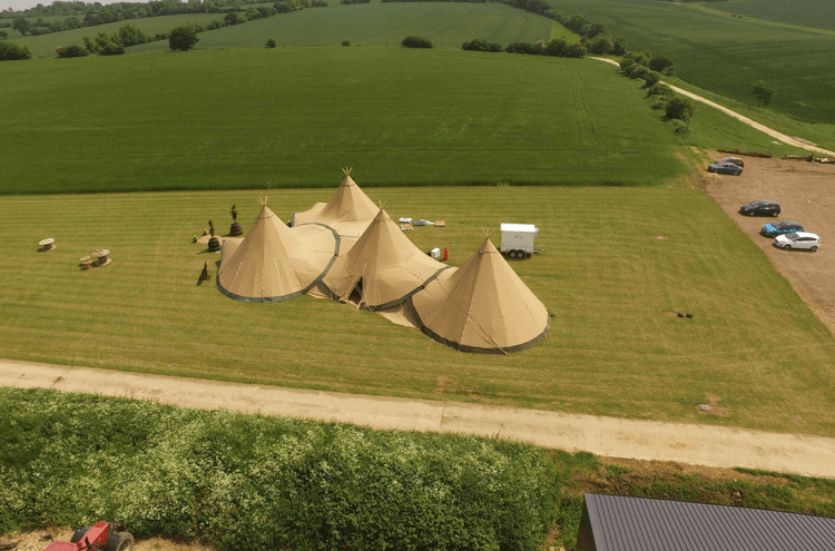 Bridebook.co.uk The Barns at Lodge Farm tipi tents in field