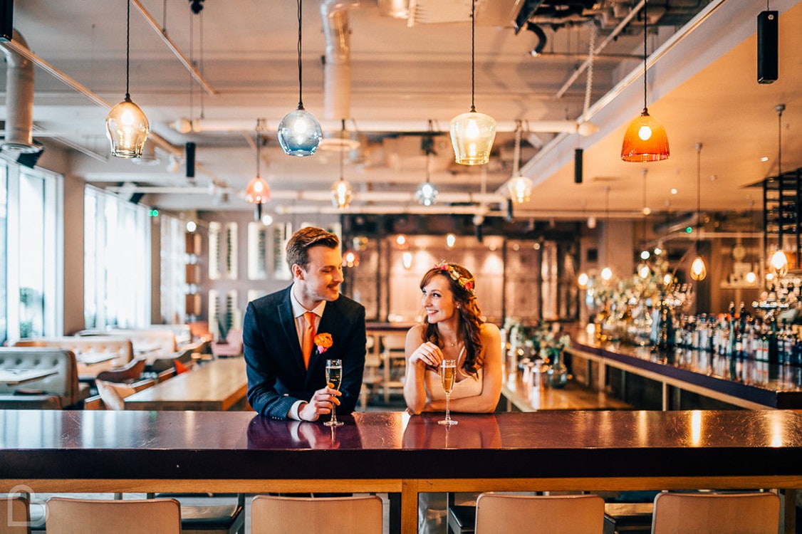 A couple drinks at The Anthologist, a modern wedding venue in the uk