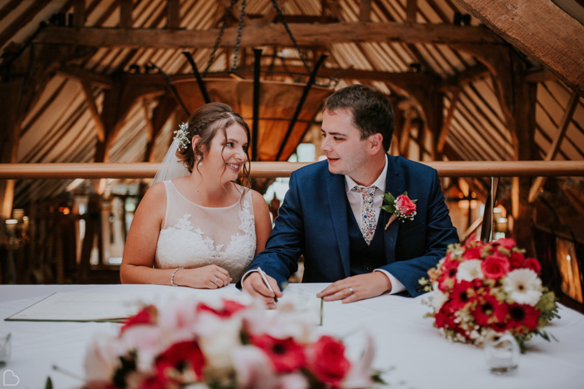 newlyweds signs their guest book at the barn in colchester