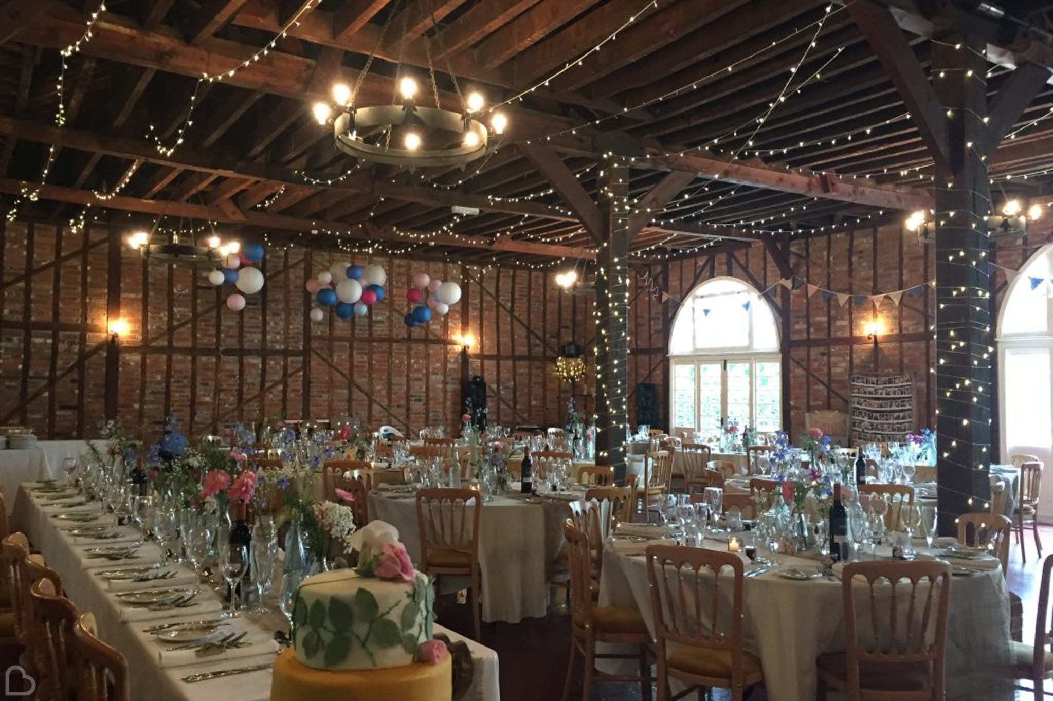 the coach house decorated with fairy lights for a wedding