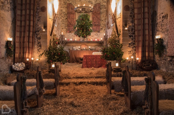 The Lost Village of Dode, an intimate wedding venue set up with hay and christmas trees for a wedding ceremony