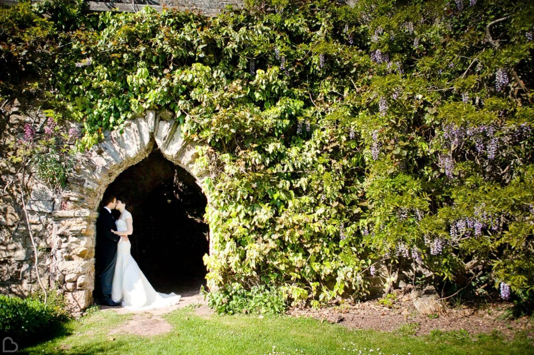 a married couple kisses in berkeley castle 