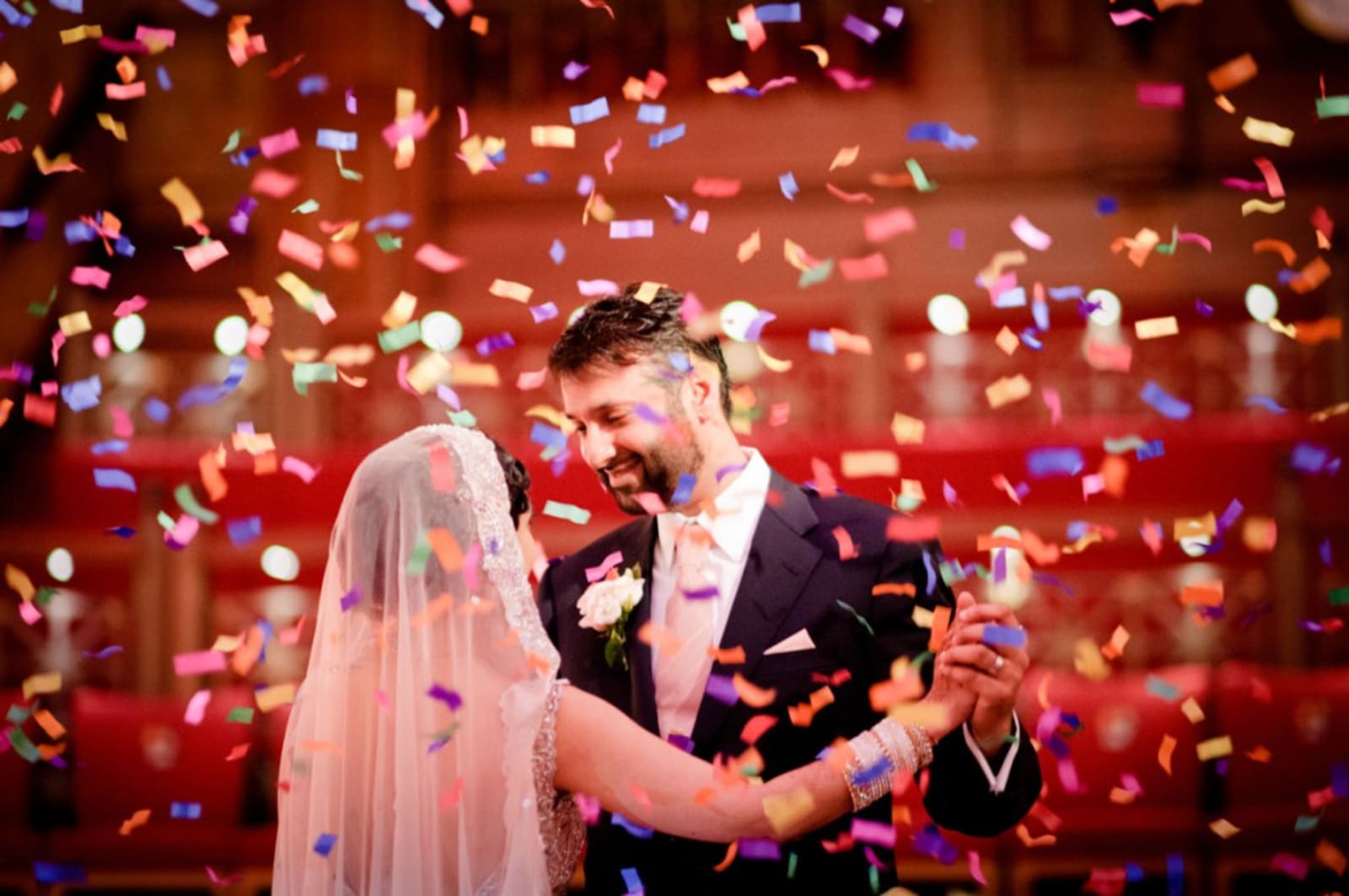 Bridebook.co.uk- bride and groom during first dance surrounded by confetti