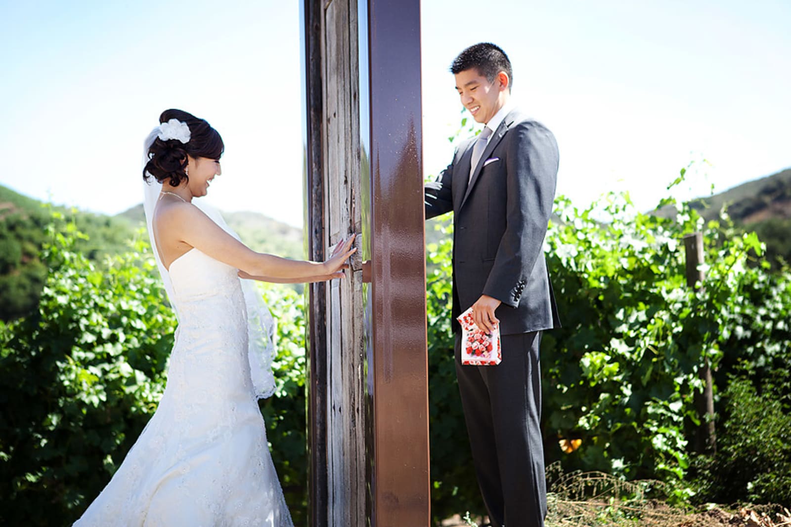 Bridebook.co.uk- bride and groom on different side of the door