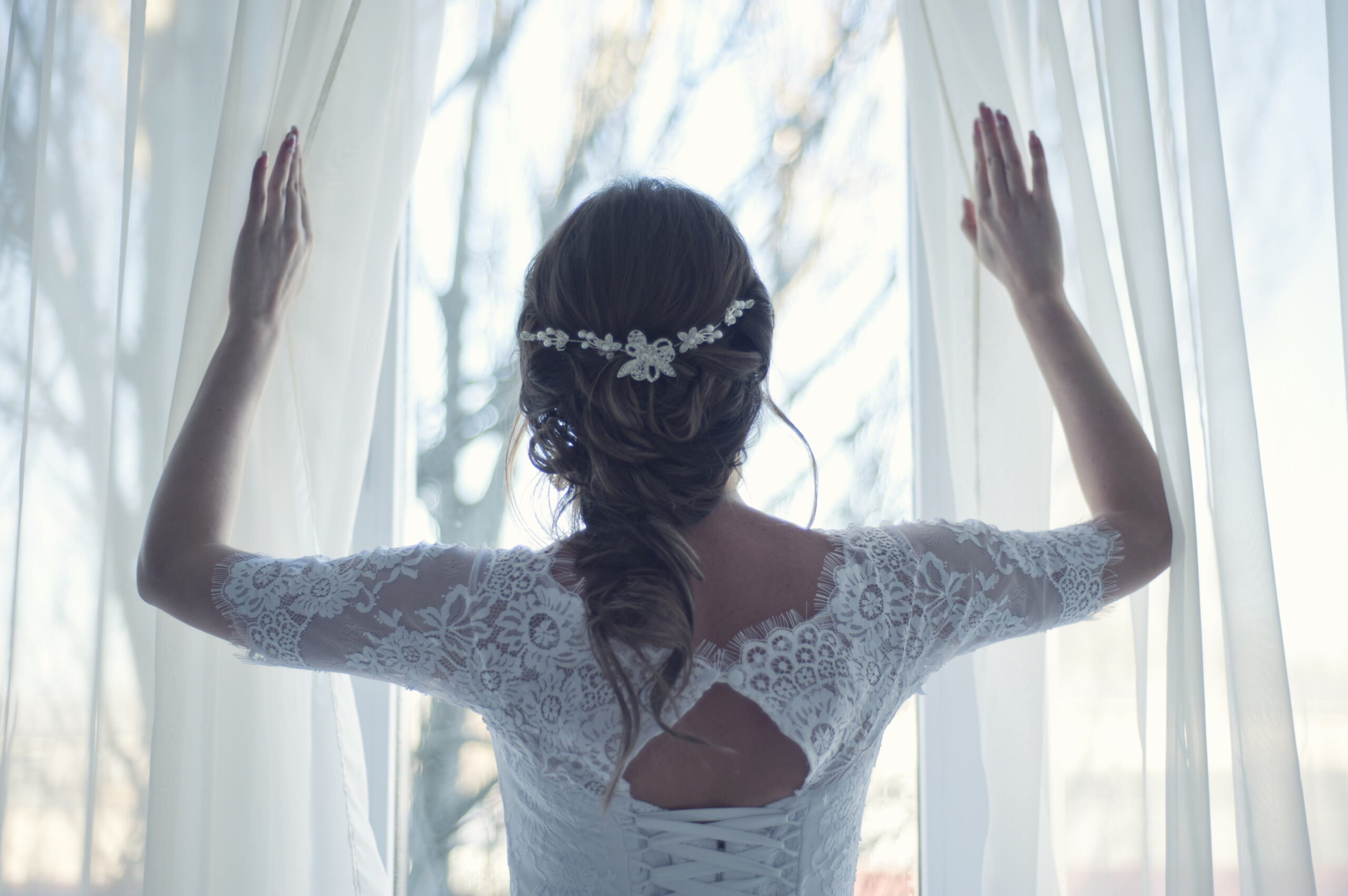 Bridebook.co.uk bride opening curtains