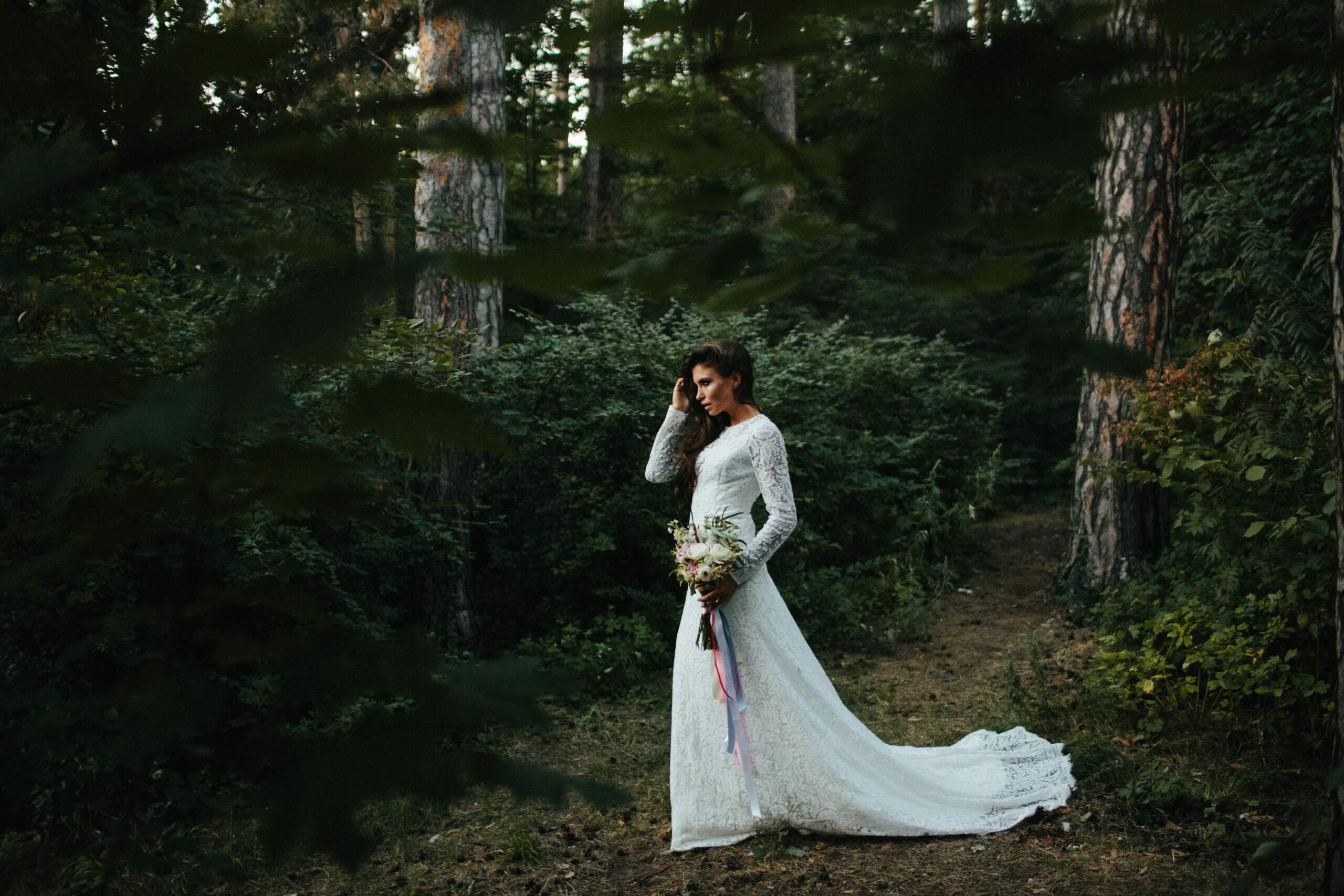 Bridebook.co.uk Boho bride at woodland wedding with long sleeved lace wedding dress