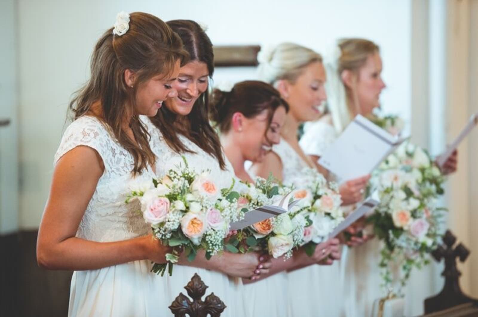 Bridebook.co.uk- bridesmaids reading from the order of service 